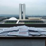 Fachada da Câmara Legislativa do DF com relógio simbolizando lei tardia para idosos no mercado de trabalho.